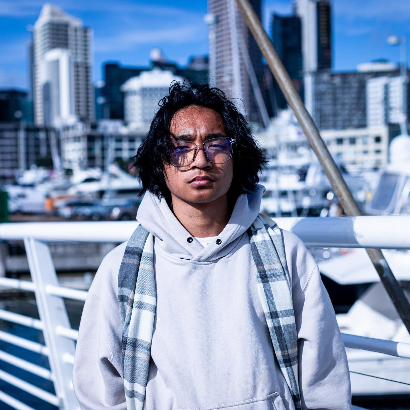 Clear BleFos frames worn with a hoodie and scarf by the waterfront
